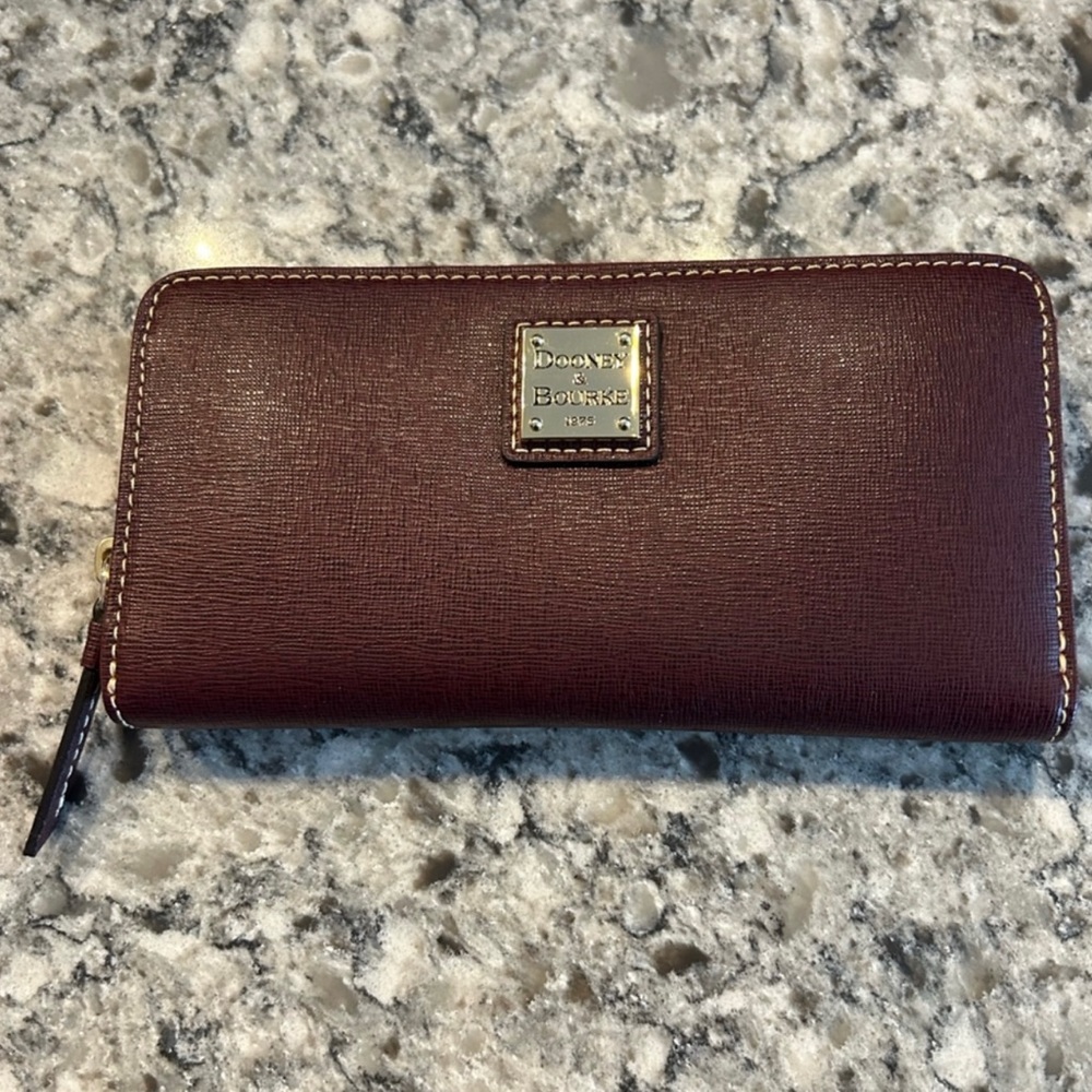 EUC - Dooney & Burke zip around wallet in color Bordeaux
$99/$138